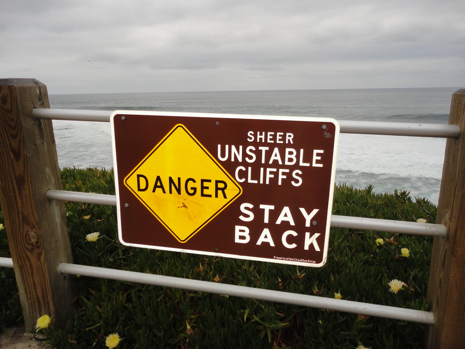 Sign says SHEER UNSTABLE CLIFFS STAY BACK